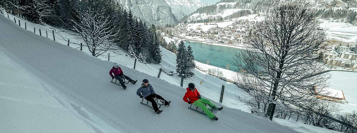 Schlitteln mit Sicht auf Eugenisee